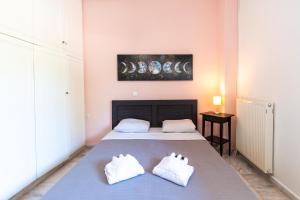 a bedroom with a bed with two white pillows at Sunset House Near Athens Airport in Spáta
