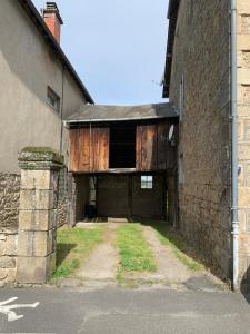 an entrance to a building with a wooden door at Treignac Tourelles in Treignac