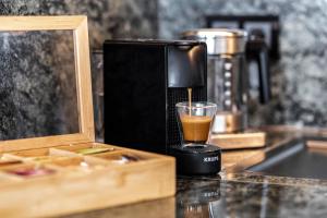 a coffee maker sitting on a counter with a glass at Apartment im Olympia Hotel Schilksee in Kiel