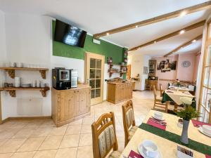 a kitchen and dining room with a table and chairs at Bed and Breakfast Galet in Ledro