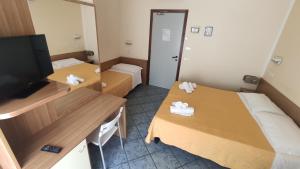 En eller flere senger på et rom på Hotel Corona