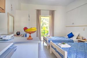 a room with two beds and a banana bowl on a table at La Casa De Dalia in Lefkímmi