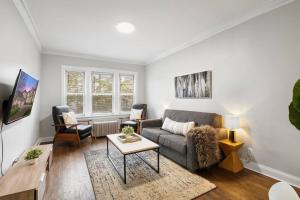a living room with a couch and a table at 2BR Stylish Apartment in Avondale close to Shops - Roscoe 1W in Chicago