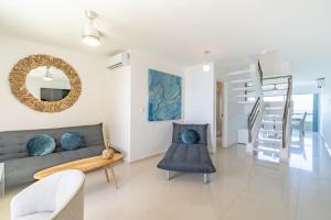 a living room with a couch and a mirror at Ocean View Three Bedroom, Three Story Penthouse by the Beach in Cancún