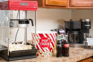 a popcorn maker and two bottles of soda on a counter at Luxe Quiet Townhouse w/Parking/Pool/By Dollywood in Pigeon Forge