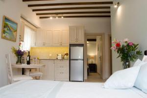 a kitchen with a refrigerator and a table at Afrodite Hotel Apartments in Myrina