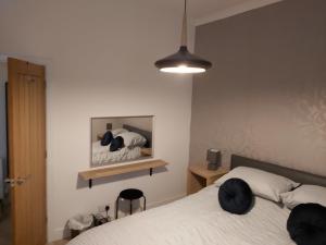 a bedroom with a white bed and a mirror at One bedroom flat, very close to Town center. in Oban