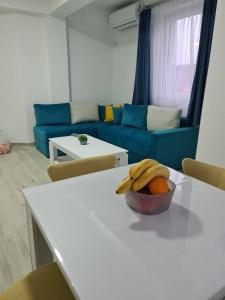 a living room with a bowl of fruit on a table at Happy apartments Strumica in Strumica
