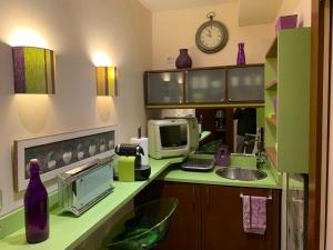 a kitchen with a counter with a sink and a microwave at Véritable Suite d'Hotel! in Orange