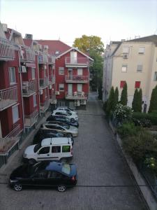 a row of cars parked in a parking lot at Apartman Boki in Vrnjačka Banja