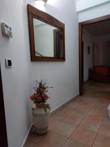 un espejo en una pared con un jarrón con una planta en Casa vacanza Giovanni Salvatori, en Orvieto Scalo