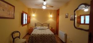 a bedroom with a bed and a ceiling fan at Casa Camille.Villares Elche de la Sierra in Elche de la Sierra