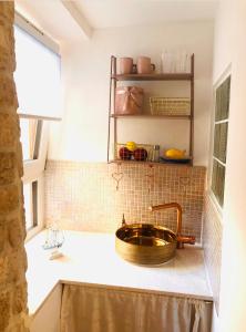 a bathroom with a copper sink and a window at Istrian stone house in the heart of the beautiful fishing village Fažana - only few steps from the sea and the wonderful beach - incl PLASMA-QUAD-PLUS-FILTER against C o v i d in Fažana