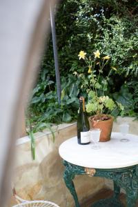 a bottle of wine sitting on a table with two glasses at Field View Lodge in Niton