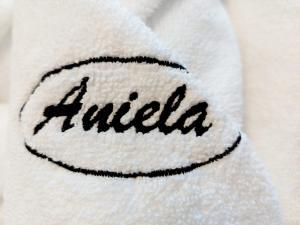 a white towel with the word india written on it at Willa Aniela in Międzyzdroje