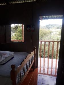 a bedroom with a bed and a large window at Finca Fuente de Vida in Estelí