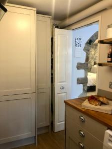 a kitchen with a dresser and a door to a closet at The Old Studio in Knaresborough