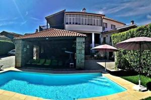 a swimming pool in front of a house at Casa do Adro de Parada in Parada de Pinhão
