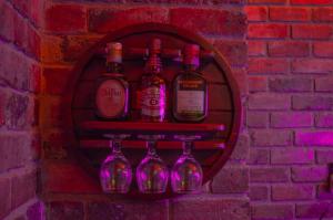 a group of wine bottles on a brick wall at El Nogal finca-hotel in Firavitoba +24 photos