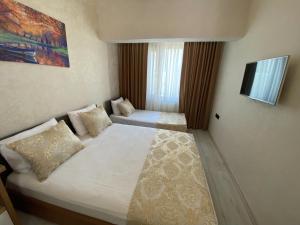 Postel nebo postele na pokoji v ubytování Boutique Sultan Hotel