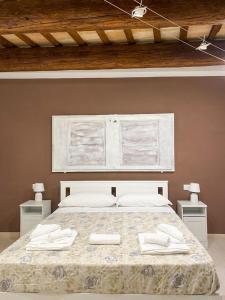 a bedroom with a bed with two towels on it at La Casa di LEO - Apartments in Recanati