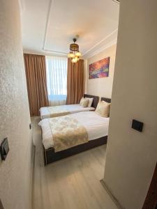Postel nebo postele na pokoji v ubytování Boutique Sultan Hotel