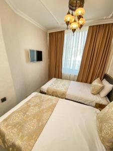 Postel nebo postele na pokoji v ubytování Boutique Sultan Hotel