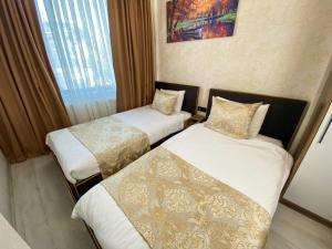 Postel nebo postele na pokoji v ubytování Boutique Sultan Hotel