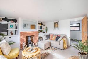 sala de estar con sofá y chimenea en Stunning character 2bed Cottage in St Albans Wifi en Saint Albans