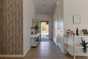 a hallway with white walls and a tile floor at The Yorba Oasis w/Pool in Palm Springs