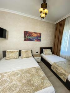 Postel nebo postele na pokoji v ubytování Boutique Sultan Hotel