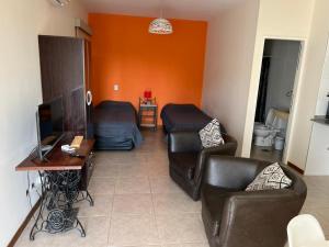a living room with two couches and a television at Alto del Bono in San Juan