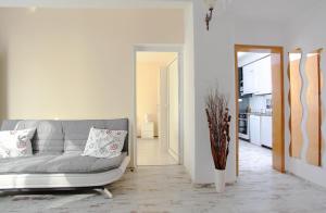 a living room with a couch and a kitchen at Raya Maisonette in Sofia
