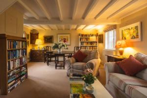 a living room with couches and a dining room with a table at Mulsford B&B in Malpas