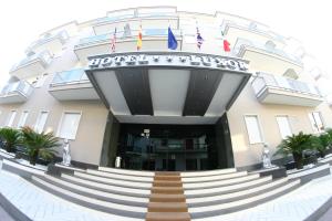 a building with a spiral staircase in front of it at Hotel Luxor in Casoria