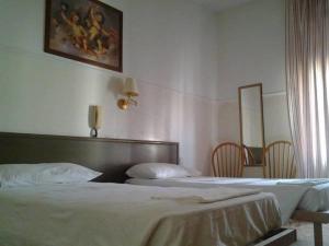 Voodi või voodid majutusasutuse Hotel Parini toas