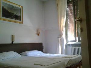 Voodi või voodid majutusasutuse Hotel Parini toas