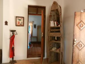 a room with a door and a book shelf at Amka Guest house in Jambiani