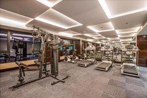 a gym with several tread machines and treadleys at Grand Sylhet Hotel & Resort in Sylhet