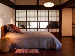 a bedroom with a bed and a large window at Casa Miyama in Nantan city
