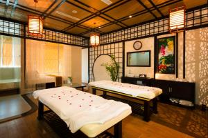 a room with two beds and a flat screen tv at Galina Hotel & Spa in Nha Trang