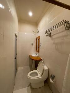 a small bathroom with a toilet and a sink at Thoddoo Retreat Grand in Thoddoo +63 photos