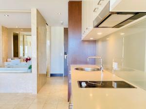 a kitchen with a sink and a counter top at 237 Santai - Second floor studio by uHoliday in Casuarina +18 photos