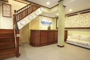 
a living room with a staircase leading to a dining room at Shore Time Hotel Boracay in Boracay
