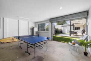 a ping pong table in the middle of a room at Sea Pine Studio in Sawtell