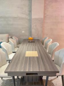 a conference room with a wooden table and chairs at Yudao 695 in Sanxing
