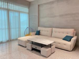 a living room with a white couch and a table at Yudao 695 in Sanxing