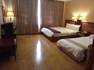 Postel nebo postele na pokoji v ubytování Stung Sangke Hotel