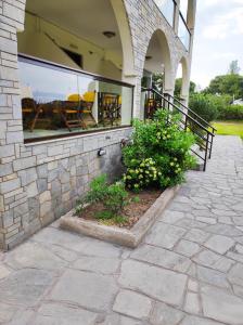 a porch of a house with a window at Aegialis Apartments (Dimitros) in Vourvourou