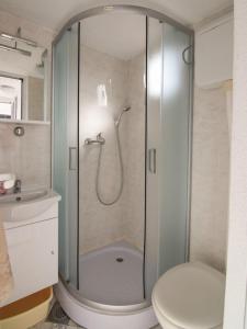a shower with a glass door in a bathroom at Apartment Pocrnja in Rogoznica +35 photos